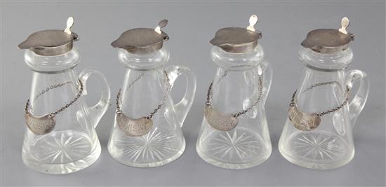 A set of four 1930s silver topped glass whisky tot jugs by Goldsmiths & Silversmiths Co Ltd,